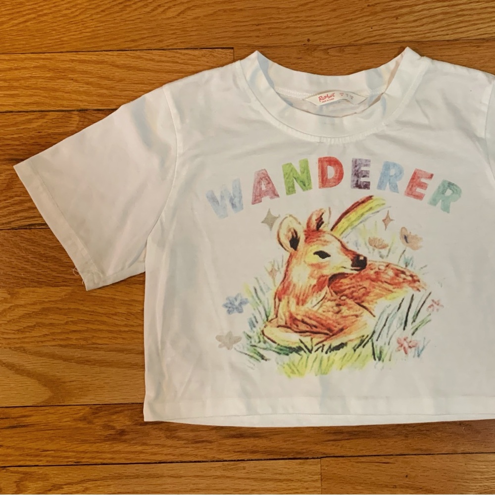 cute white cropped tee, with multi-colored text (“wanderer”) & baby deer design